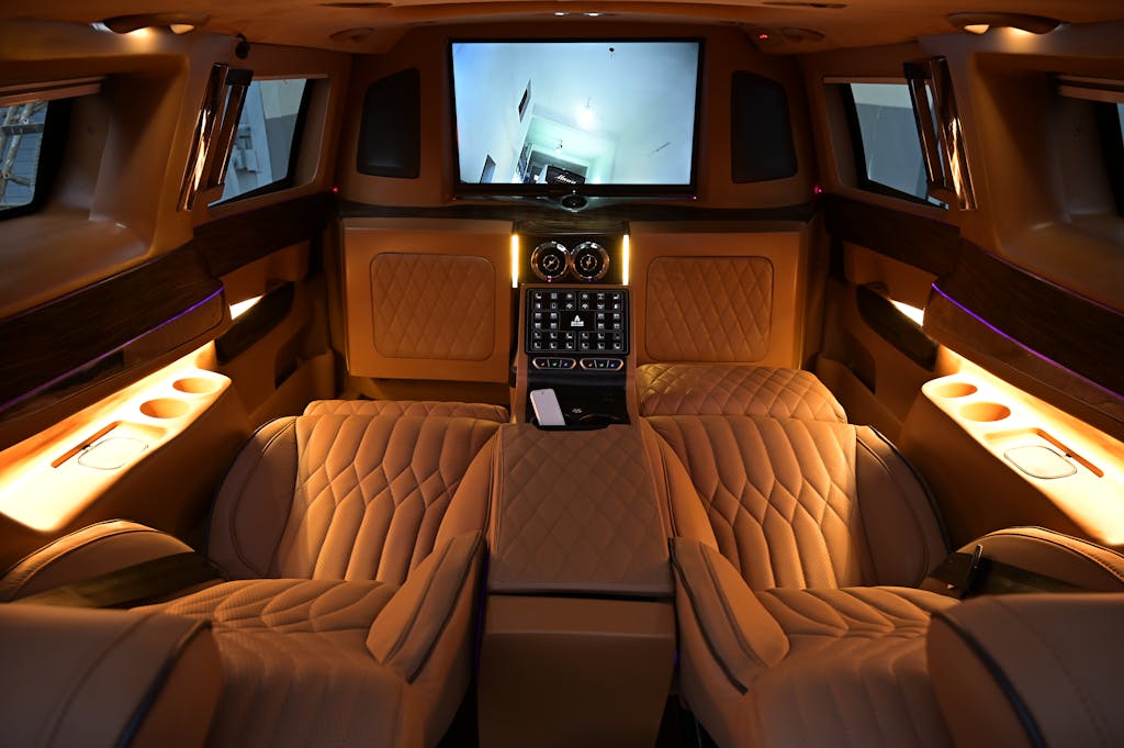 Elegant limousine interior featuring plush leather seats and ambient lighting for ultimate comfort.